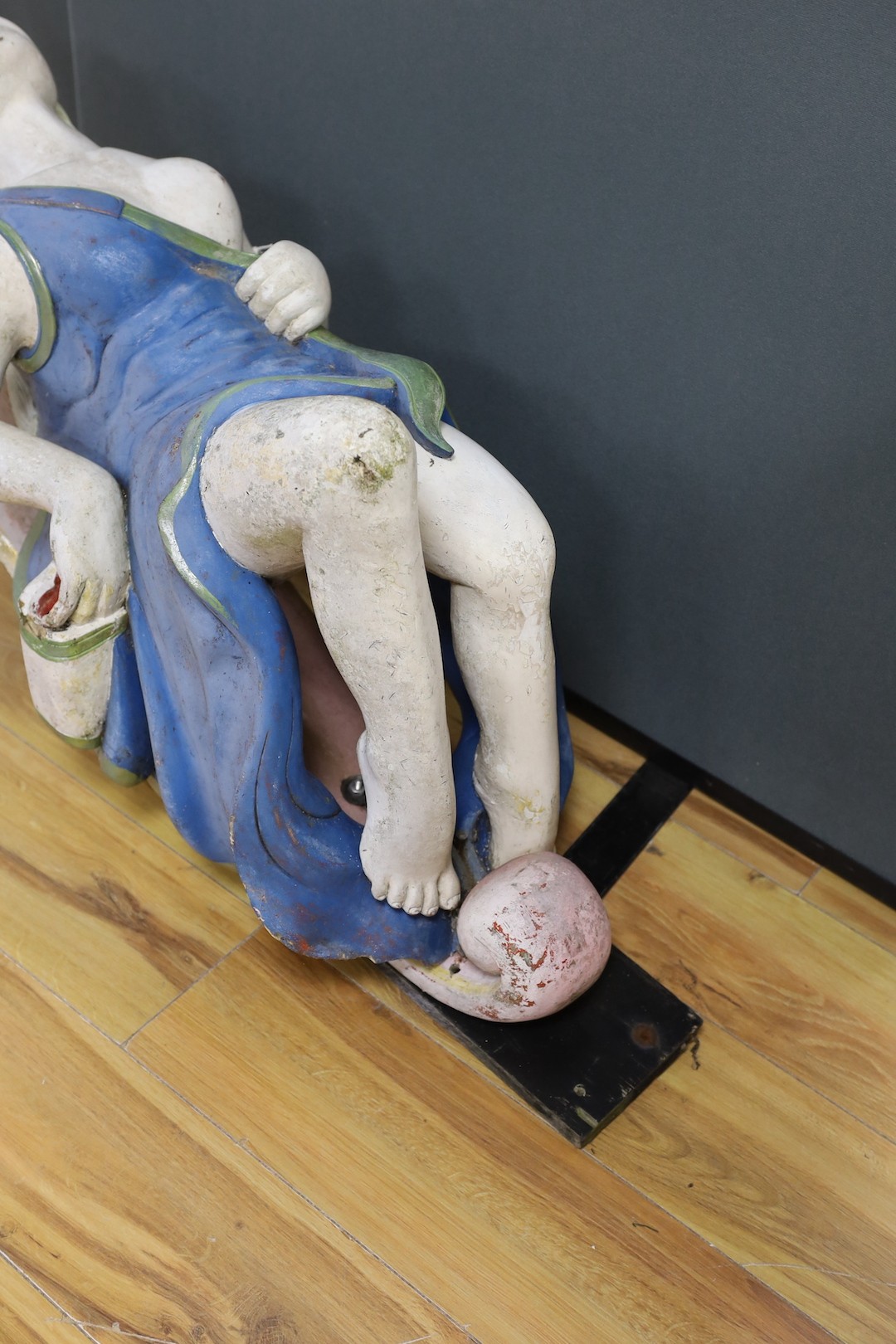 A painted wood and gesso female figurehead reclining - 74cm deep, 93cm high